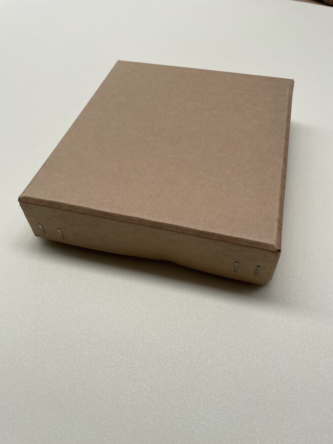Brown cardboard box on white surface.